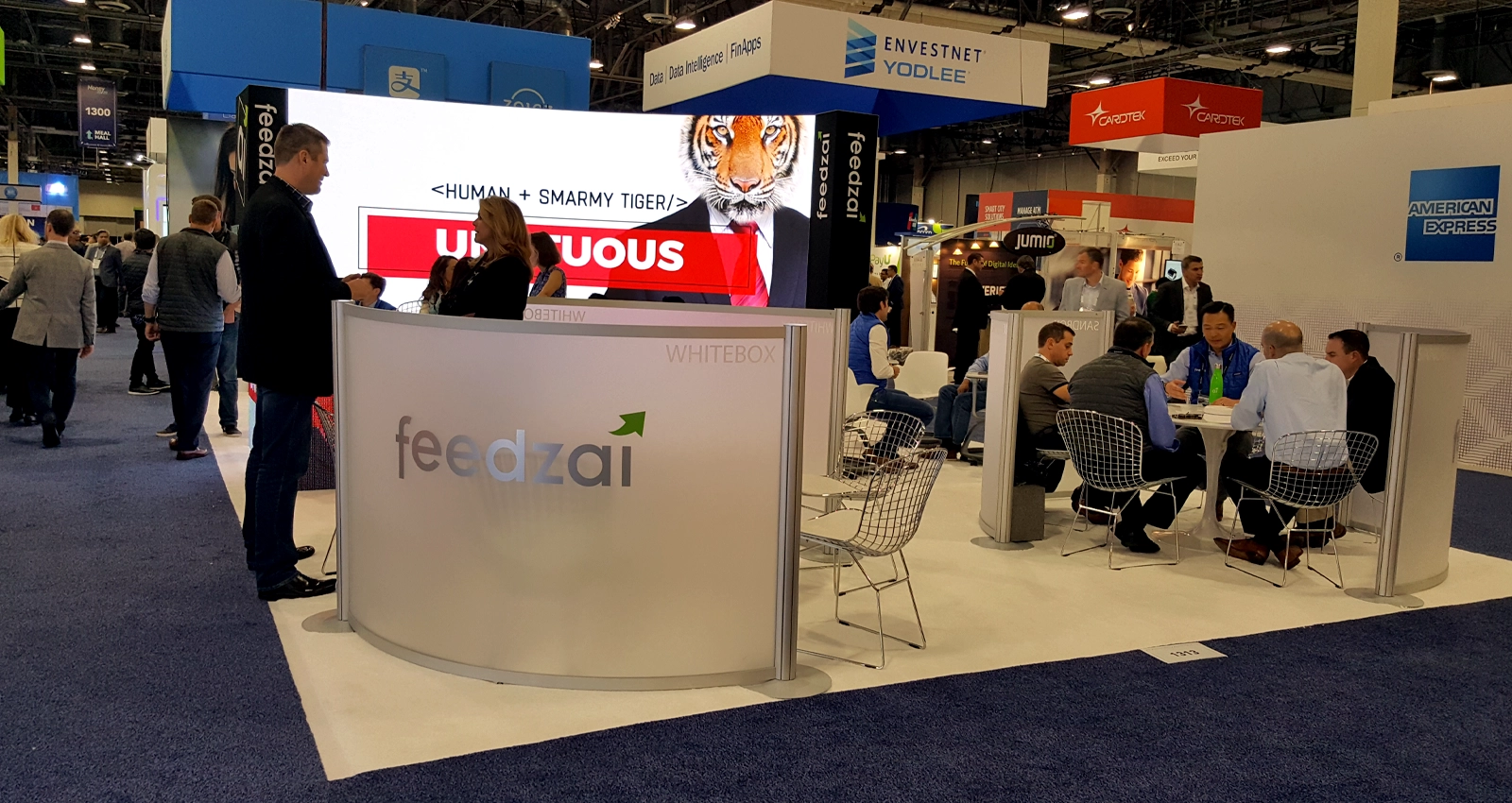 20x30 custom trade show booth with LED video wall, meeting space, counters, and branded exhibit structure