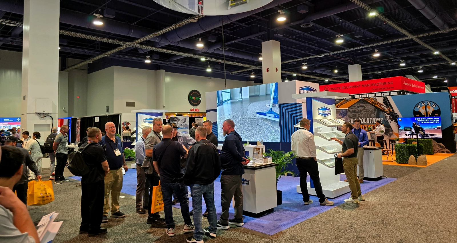 30x20 custom trade show exhibit with LED video wall, branded reception counter, and product demo space